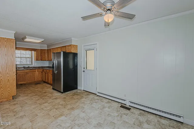 a view of a kitchen with a sink and refrigerator
