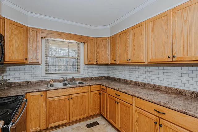 a kitchen with stainless steel appliances granite countertop white cabinets sink and dishwasher