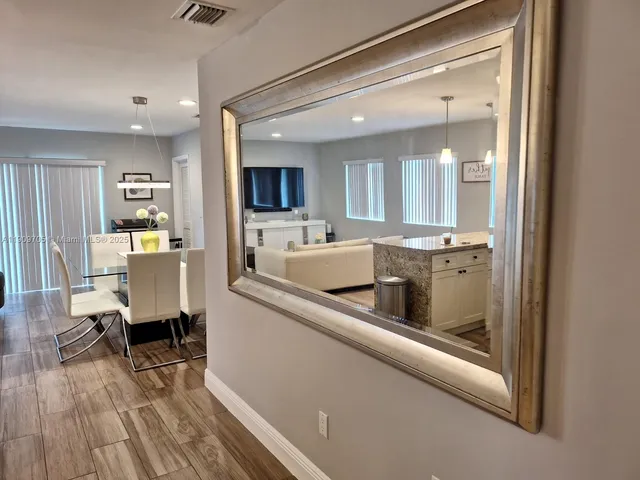 a kitchen with kitchen island wooden cabinets and stainless steel appliances