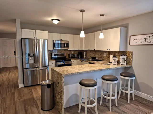 a bedroom with furniture and a flat screen tv