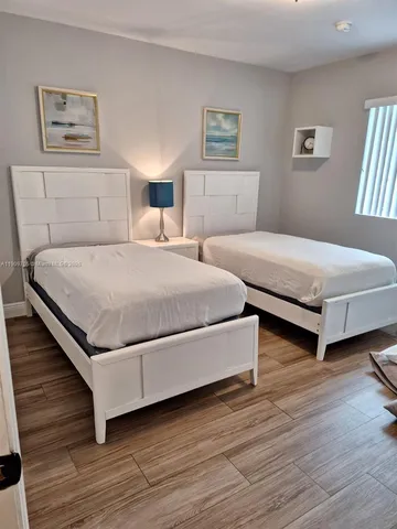 a bedroom with bed and window