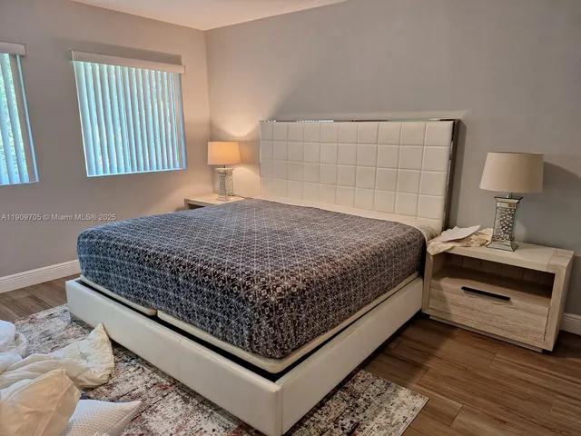 a bedroom with a bed and a night stand