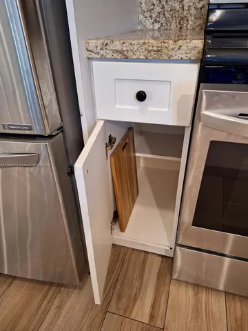 a view of a house with a yard and potted plants