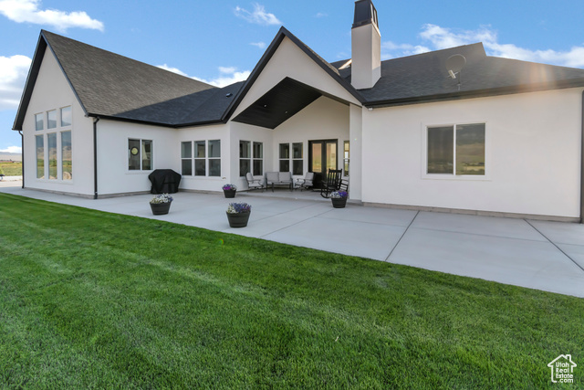1952 Highway 118 Monroe, UT 84754 - Photo 11 of 88 Back of property featuring a chimney, a patio area, a lawn, stucco siding, and a shingled roof