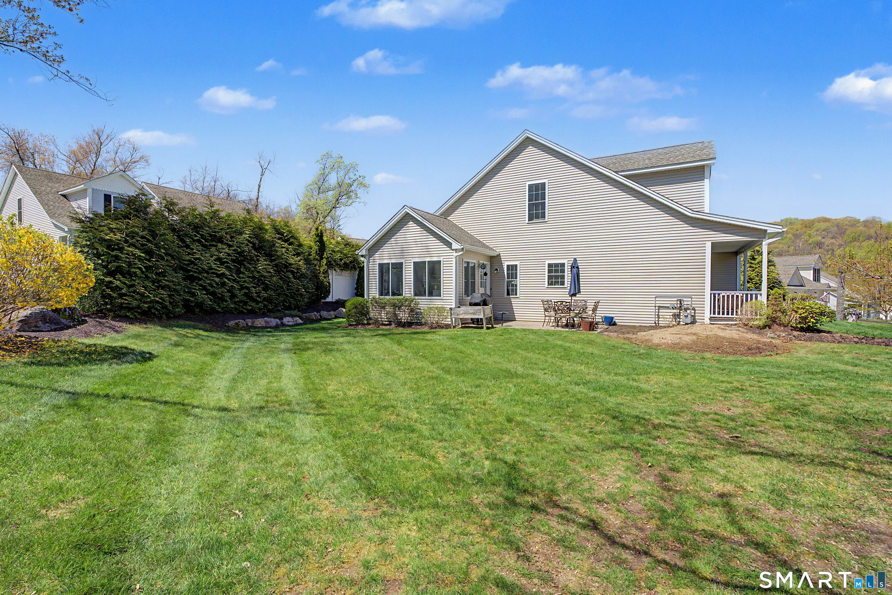 211 Meadowbrook Road, Unit 211 Oxford, CT 06478 - Photo 36 of 38 Spacious backyard bordered by mature landscaping, offering a peaceful setting with room to enjoy the outdoors.