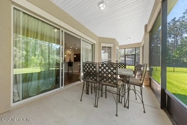 a dining room with furniture and garden view