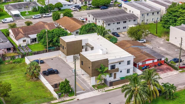 an aerial view of a house with garden space and street view