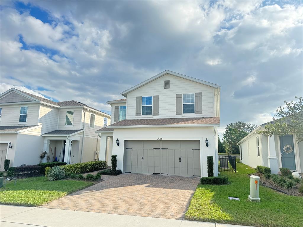 a front view of a house with a yard and garage