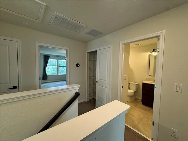 a en suite bathroom with a granite countertop sink and a mirror