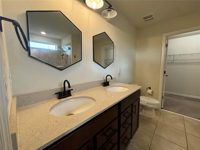a bathroom with a shower and a sink