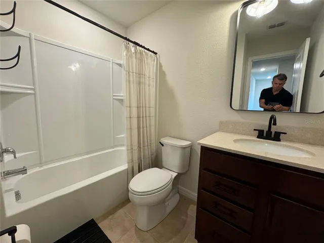 an empty room with windows and entrance