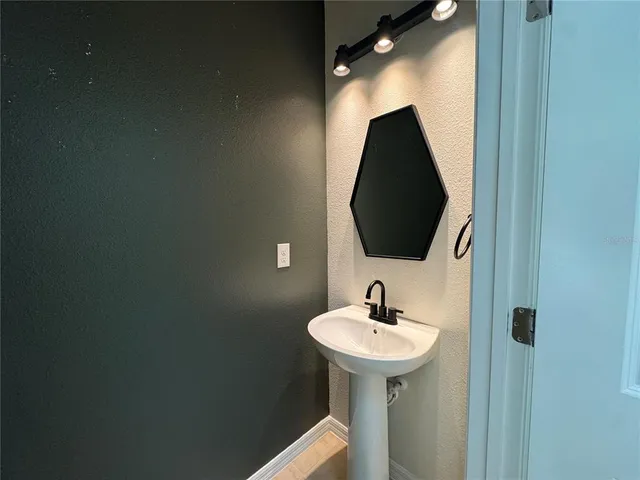 a bathroom with a sink and mirror