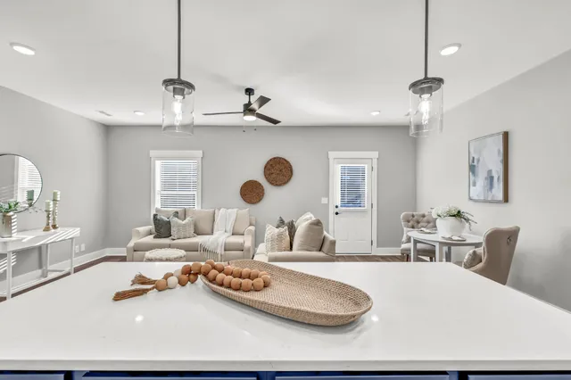 a living room with furniture and a chandelier