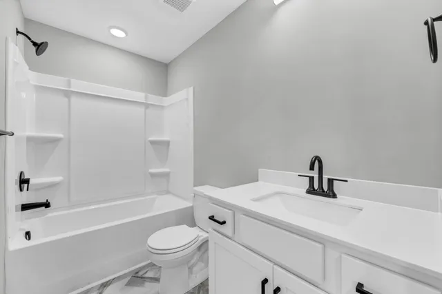 a bathroom with a sink a toilet and a bathtub