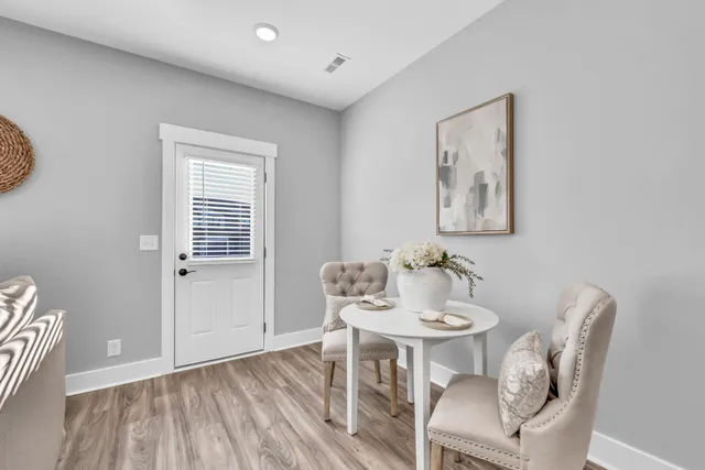 a view of a dining room with furniture and wooden floor