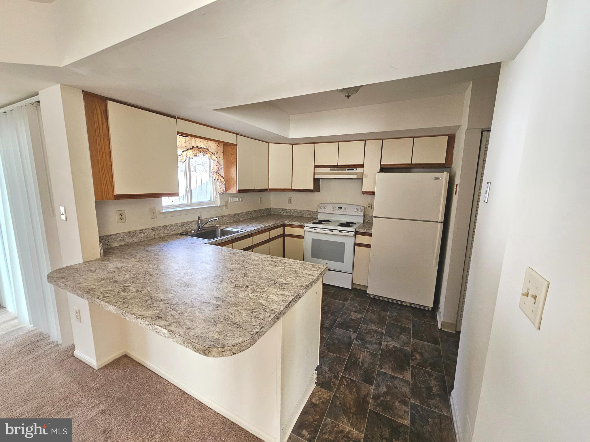 38 Heatherfield Way Dover, DE 19904 - Photo 9 of 26 a kitchen with stainless steel appliances granite countertop a sink stove and refrigerator