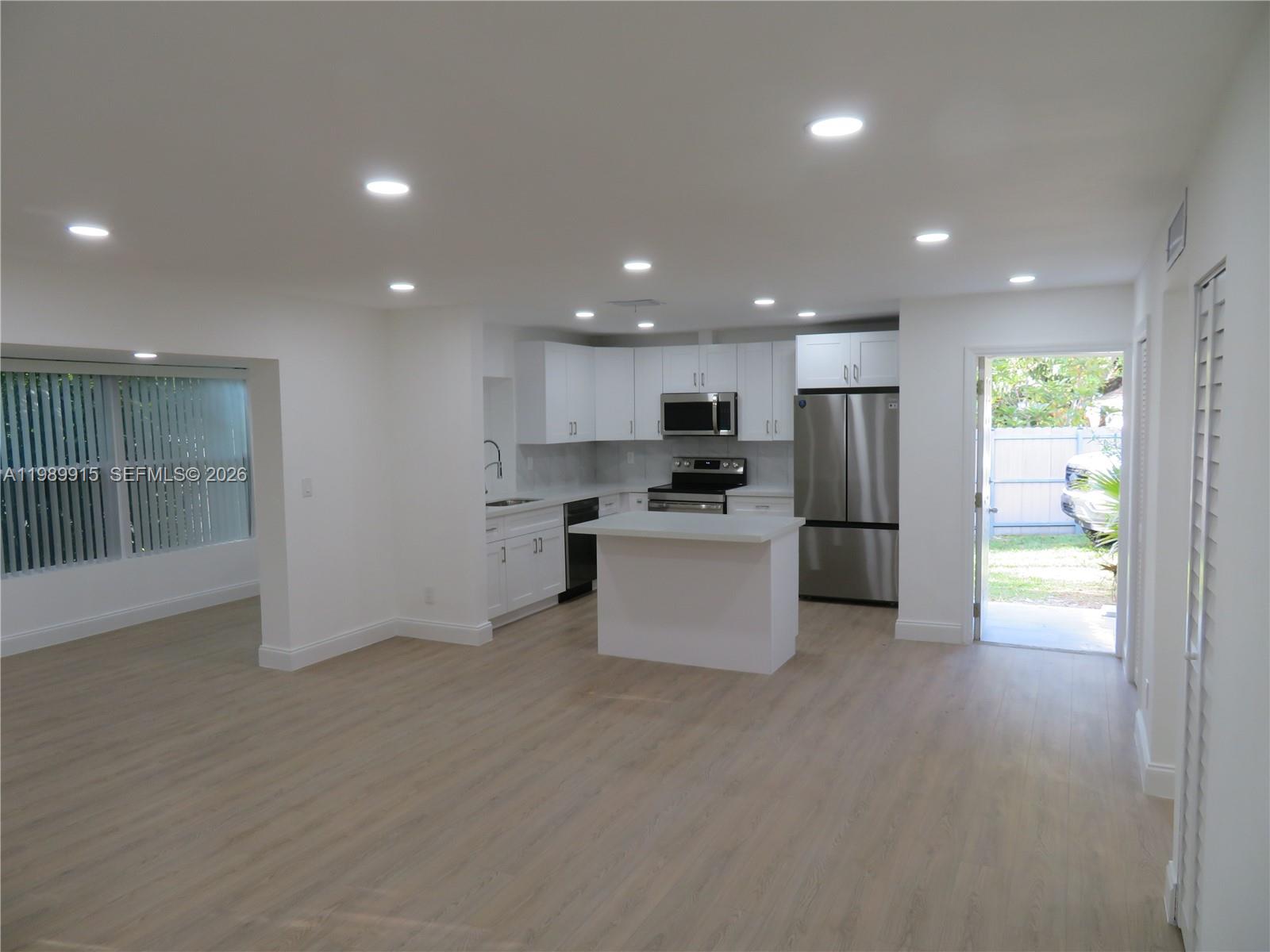 17247 Southwest 112th Place, Unit 21044 Miami, FL 33157 - Photo 7 of 21 a large kitchen with stainless steel appliances a refrigerator and a stove top oven