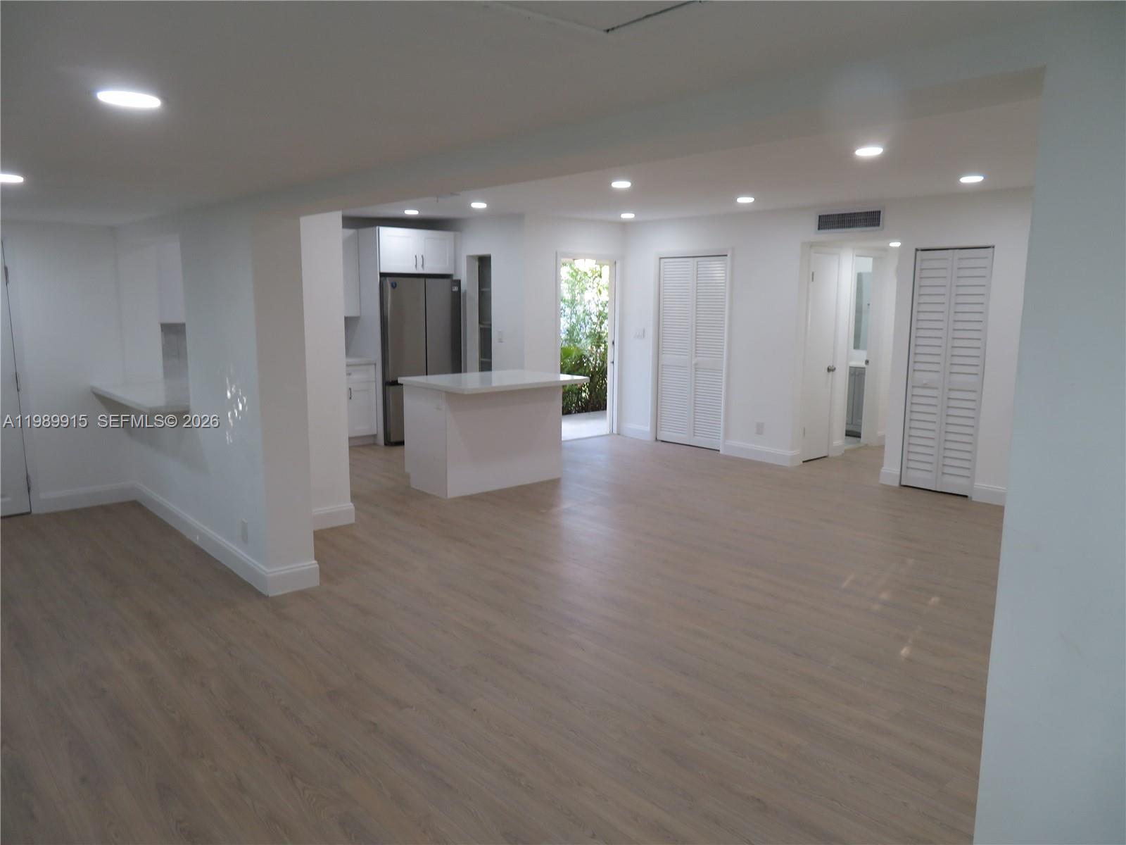 17247 Southwest 112th Place, Unit 21044 Miami, FL 33157 - Photo 8 of 21 a view of a big room with wooden floor and windows