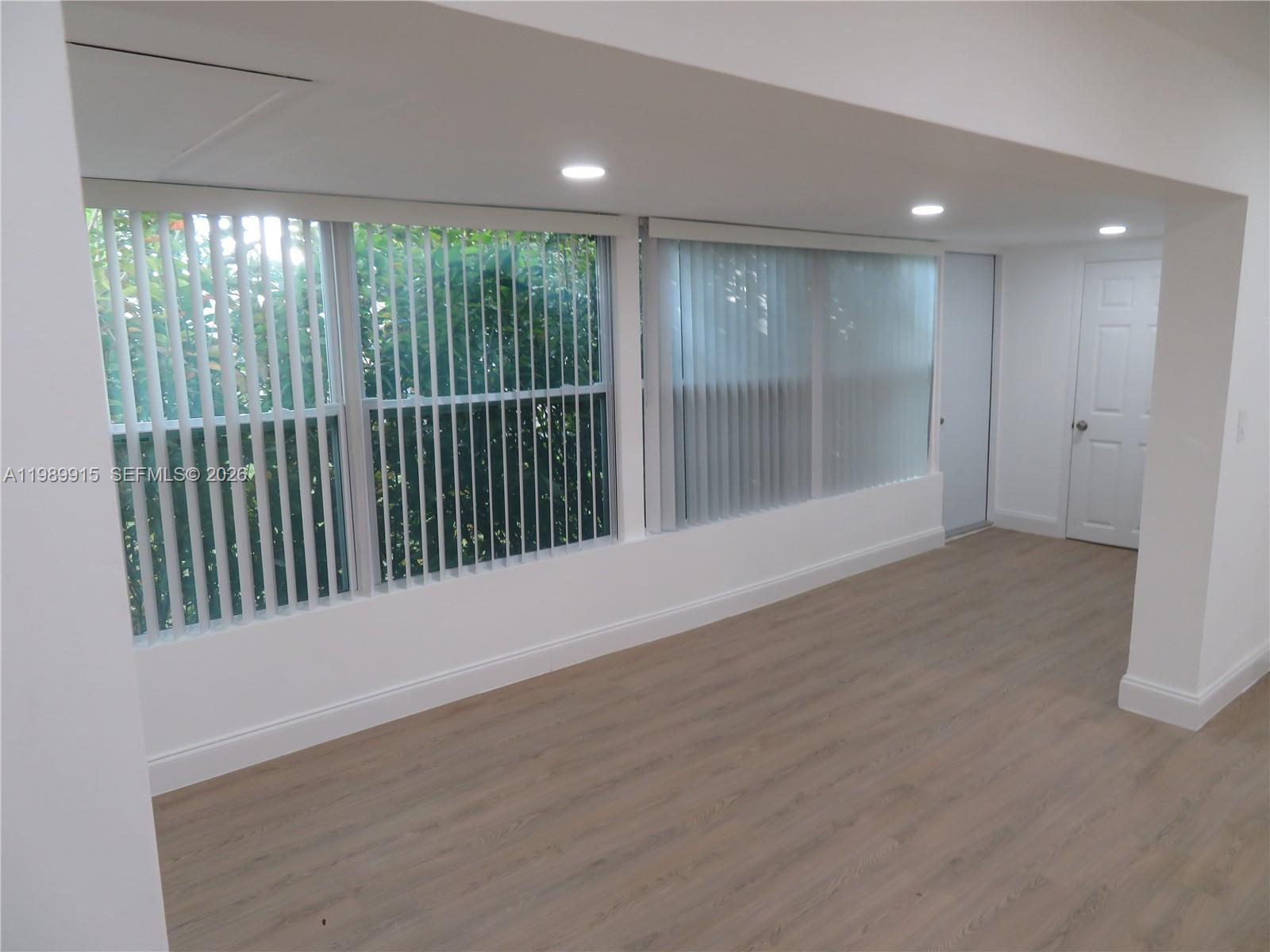 17247 Southwest 112th Place, Unit 21044 Miami, FL 33157 - Photo 10 of 21 a view of an empty room with a sliding door