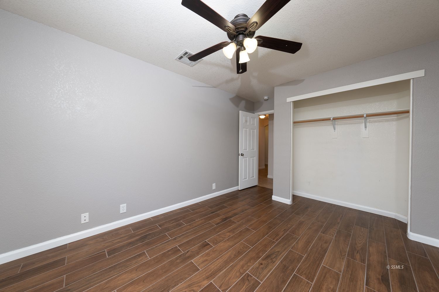 1009 Sims Street Ridgecrest, CA 93555 - Photo 15 of 40 a view of an empty room with wooden floor