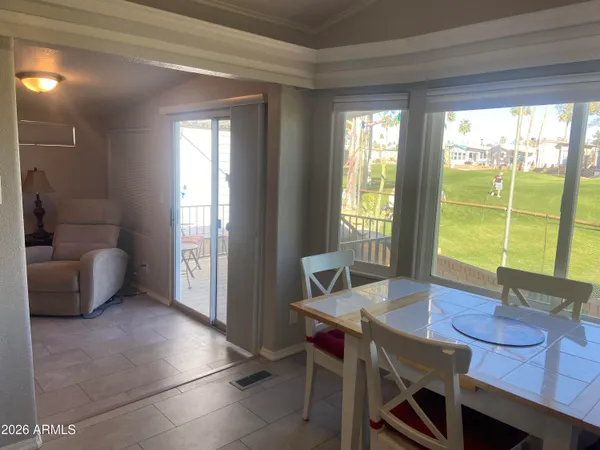 a dining room with furniture a window and a projector