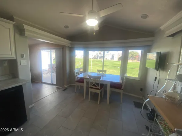 a view of a dining room with furniture and a floor to ceiling window