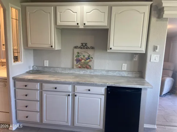 a kitchen with a stove and a white refrigerator