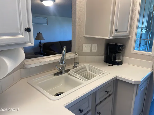 a bed sitting in a room next to a window