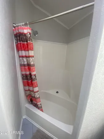 a bed sitting in a room next to a window