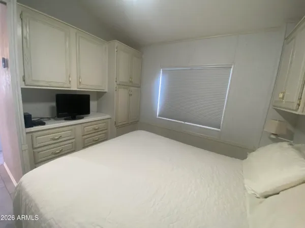 a bedroom with a bed and a mirror