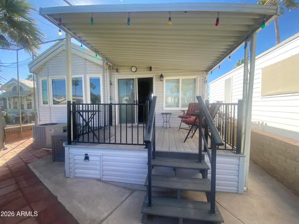 a view of a porch with furniture and wooden floor