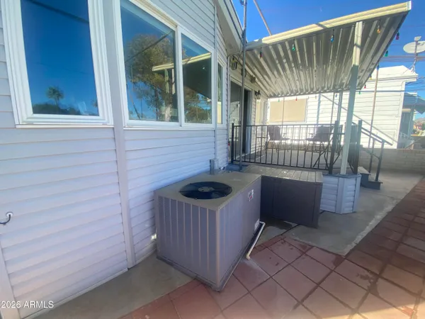 a front view of a house with a garden and lake view