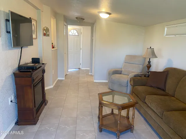 a view of a dining room with furniture and window