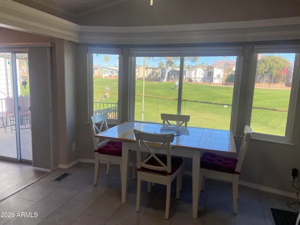 a view of a dining room with furniture and window