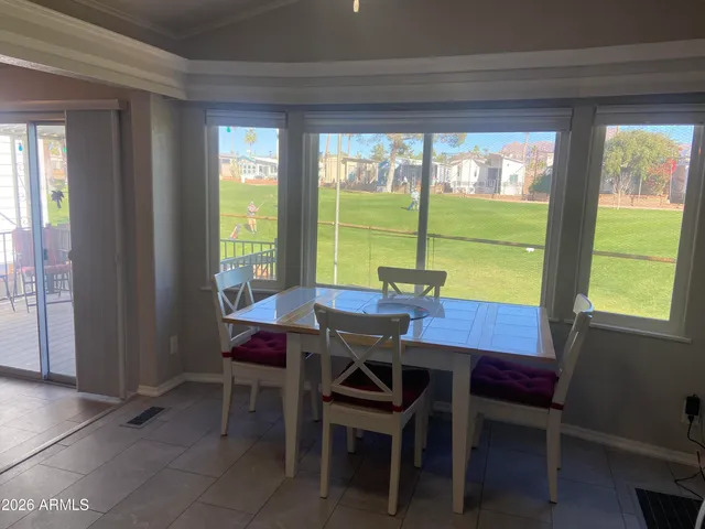 a view of a dining room with furniture and a floor to ceiling window