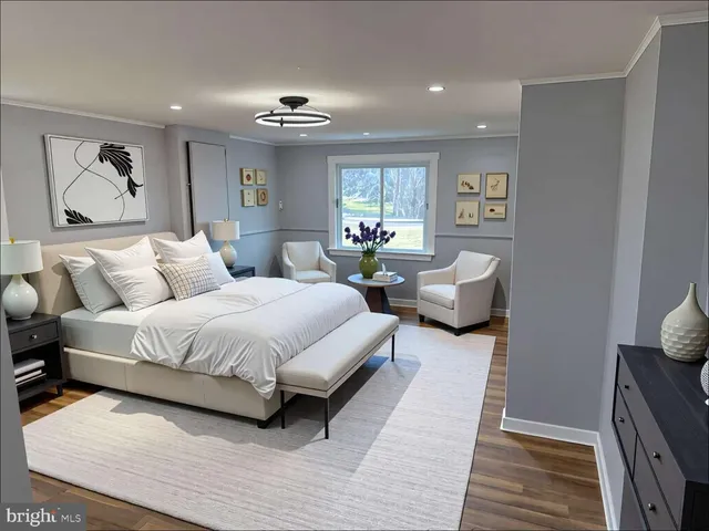 a spacious bedroom with a bed couch and window