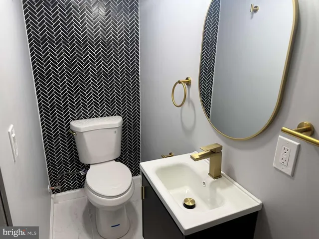 a white toilet sitting next to a bathroom sink
