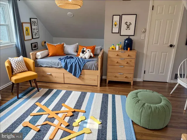 a bedroom with a bed and painting on the wall