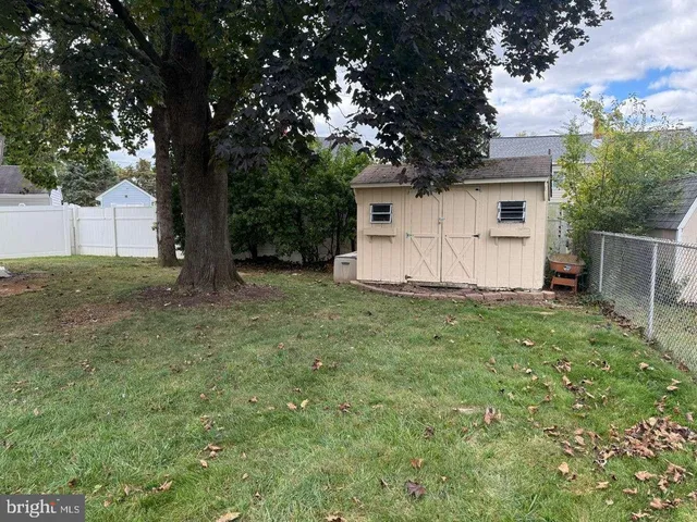 a view of a house with a tree and a yard