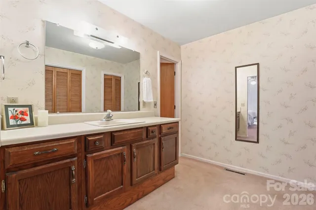 a spacious bathroom with a double vanity sink and a mirror