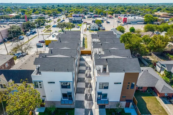an aerial view of residential houses with outdoor space