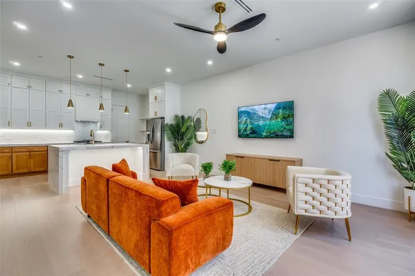 a living room with furniture and a potted plant