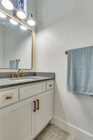 a bathroom with a double vanity sink and a mirror