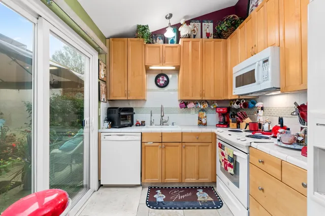 a kitchen with a refrigerator and a stove