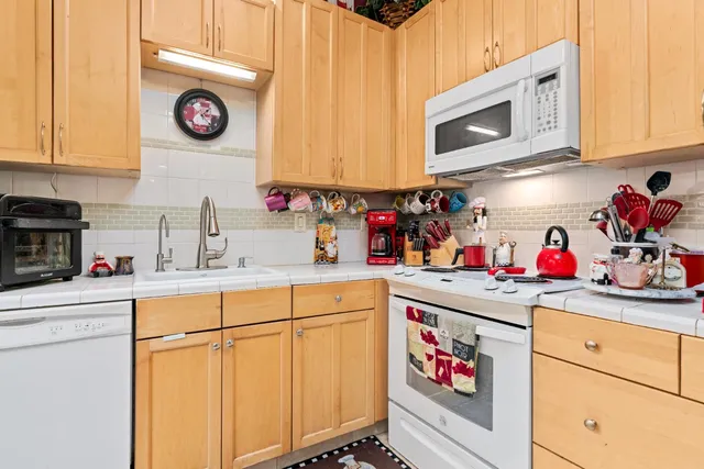 a kitchen with stainless steel appliances granite countertop a sink and a microwave