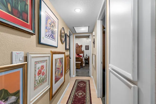 a hallway with painting on the wall
