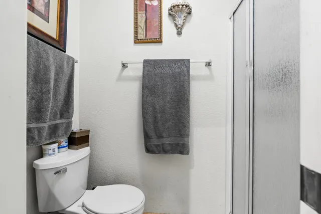 a white toilet sitting next to a bathroom sink