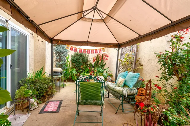 a view of an chairs and table in the patio