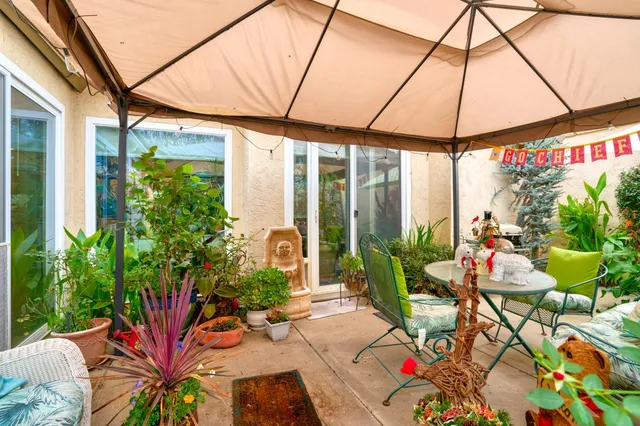a view of an outdoor dining space with a patio
