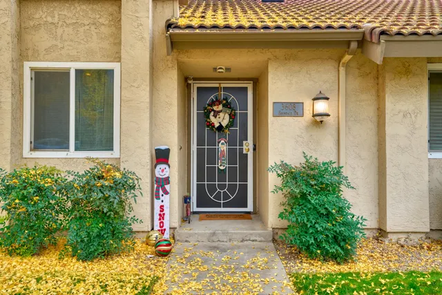 a front view of a house with plants